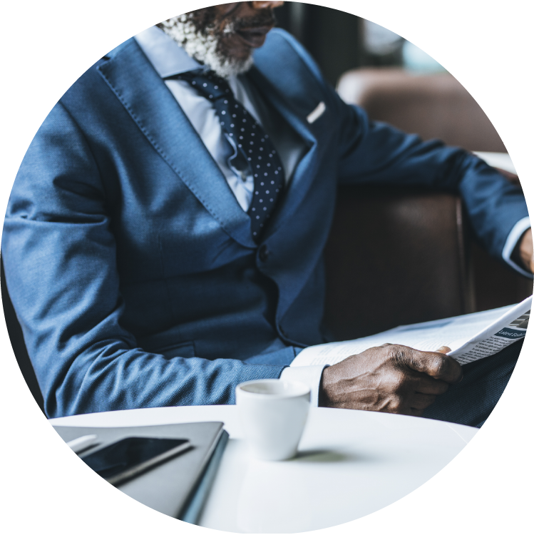 Man in a suit reading the newspaper