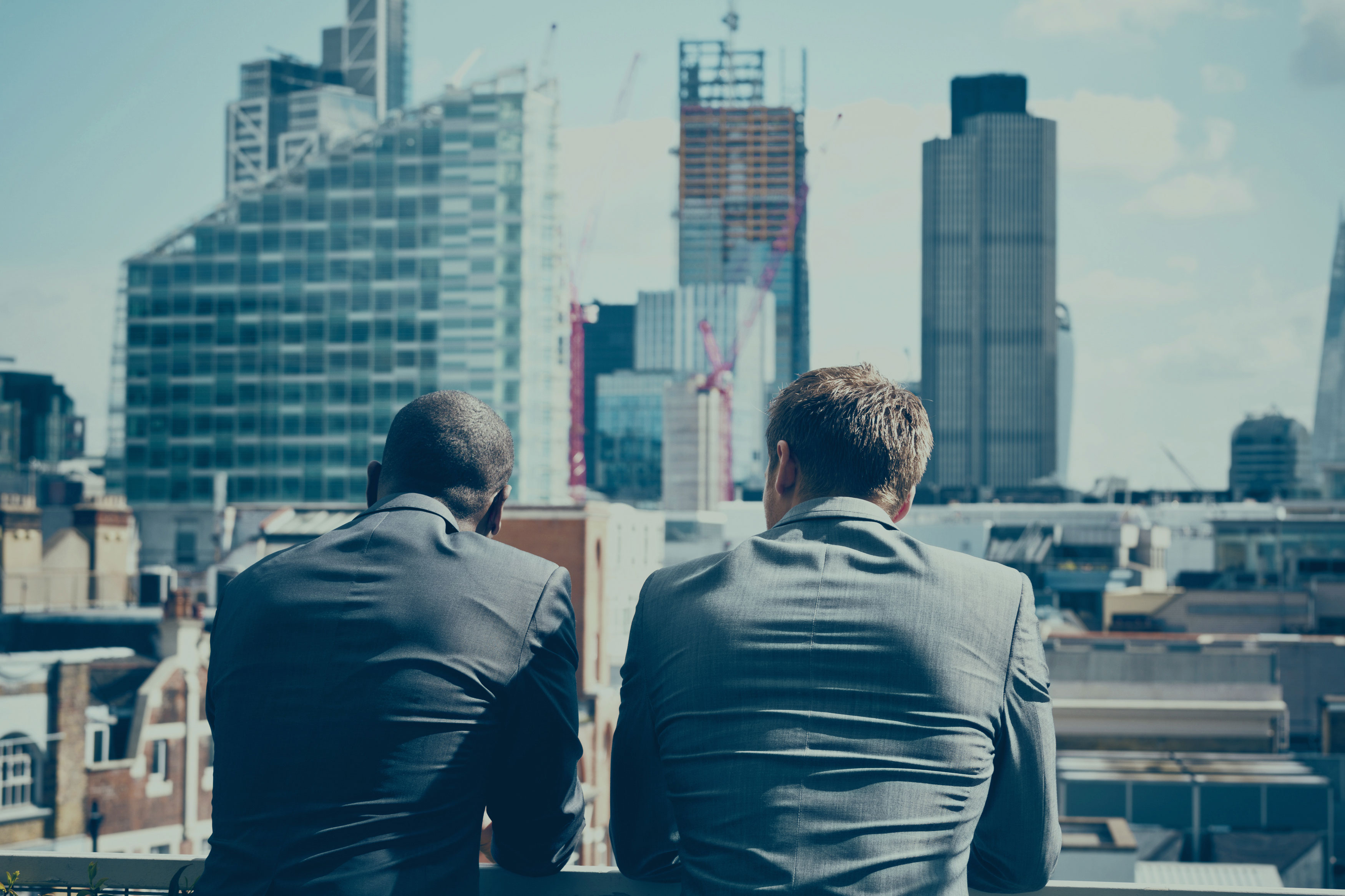 Two men overlooking a city skyline